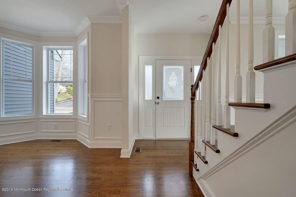 113 Lanyard Road Manahawkin, NJ 08050 - Photo 12 of 71 an empty room with wooden floor and windows