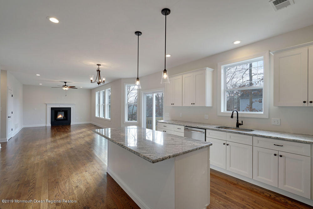 113 Lanyard Road Manahawkin, NJ 08050 - Photo 28 of 71 a kitchen with stainless steel appliances granite countertop a sink a center island and windows