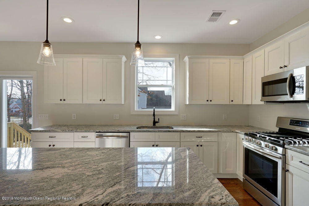 113 Lanyard Road Manahawkin, NJ 08050 - Photo 29 of 71 a kitchen with a sink stove and microwave