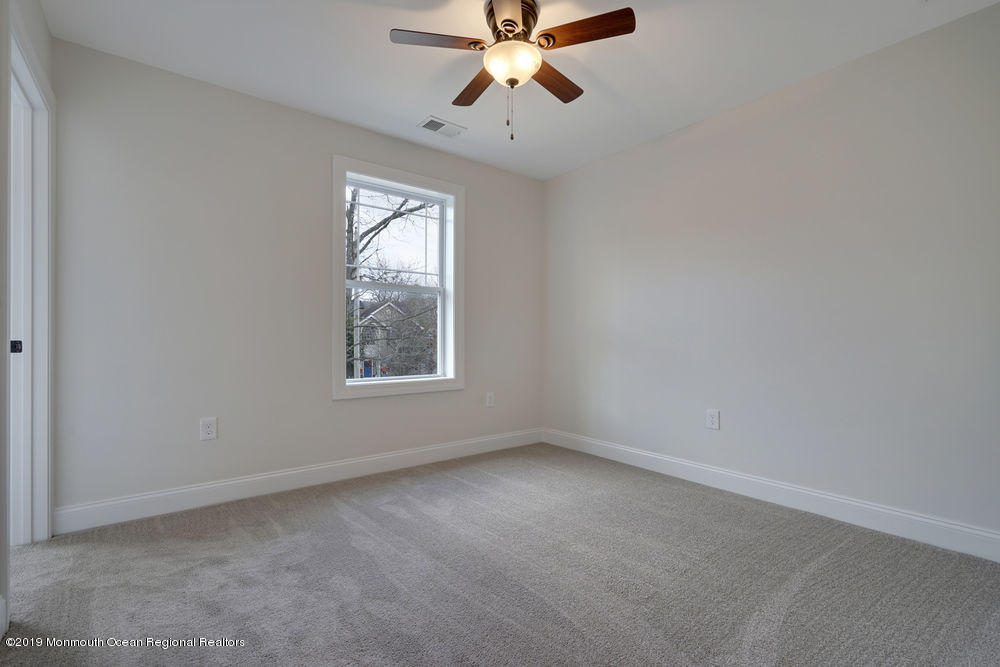 113 Lanyard Road Manahawkin, NJ 08050 - Photo 36 of 71 an empty room with a window and a fan