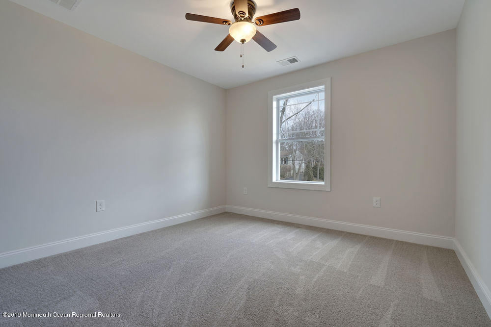 113 Lanyard Road Manahawkin, NJ 08050 - Photo 43 of 71 an empty room with a window and a fan
