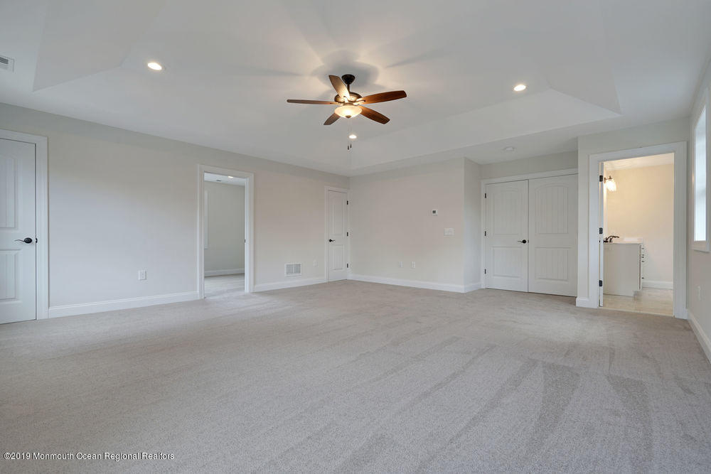 113 Lanyard Road Manahawkin, NJ 08050 - Photo 47 of 71 an empty room with chandelier fan and windows