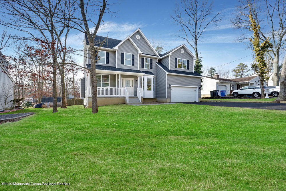 113 Lanyard Road Manahawkin, NJ 08050 - Photo 5 of 71 a front view of a house with a garden and trees