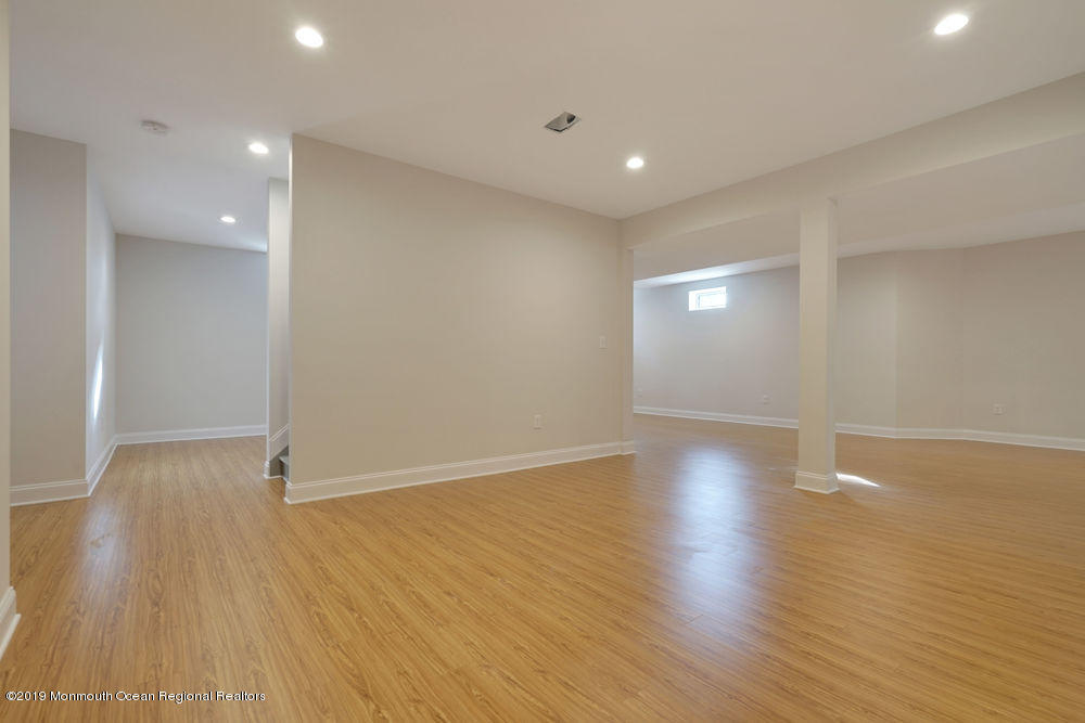 113 Lanyard Road Manahawkin, NJ 08050 - Photo 55 of 71 a view of an empty room with wooden floor