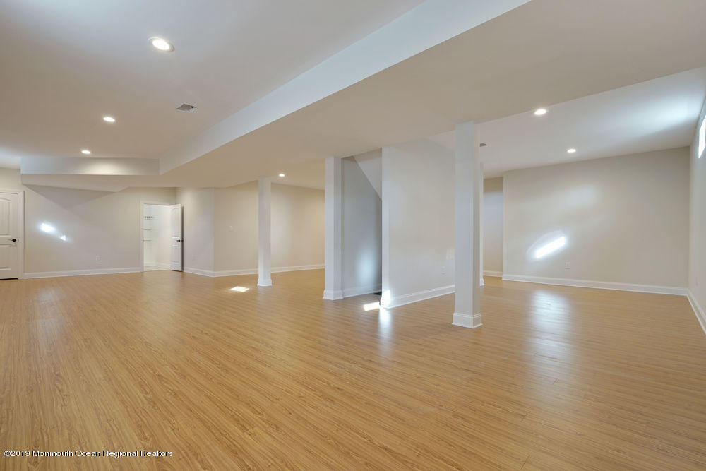 113 Lanyard Road Manahawkin, NJ 08050 - Photo 57 of 71 a view of an empty room with wooden floor