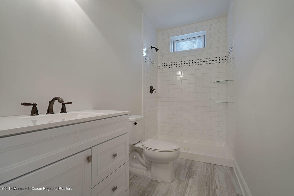 113 Lanyard Road Manahawkin, NJ 08050 - Photo 58 of 71 a bathroom with a sink a toilet and shower