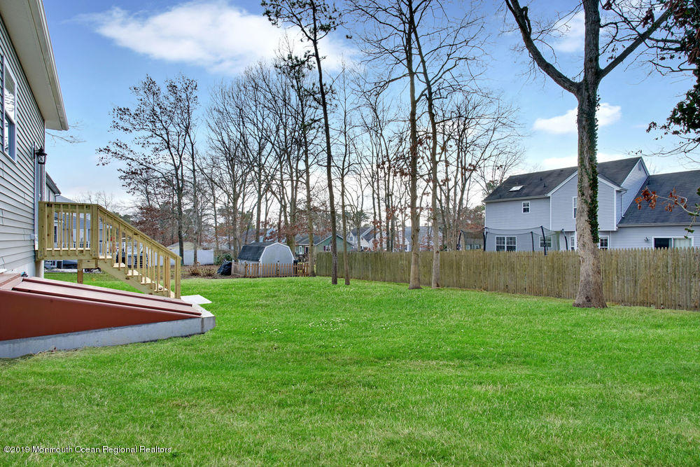 113 Lanyard Road Manahawkin, NJ 08050 - Photo 60 of 71 a backyard of a house with lots of green space