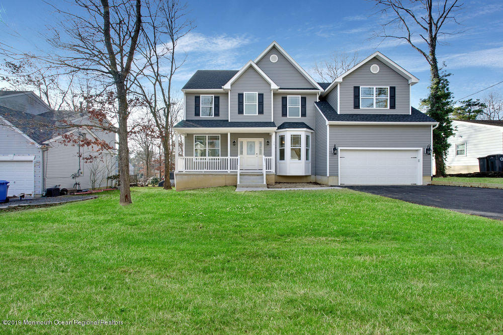 113 Lanyard Road Manahawkin, NJ 08050 - Photo 6 of 71 a front view of a house with a garden and trees