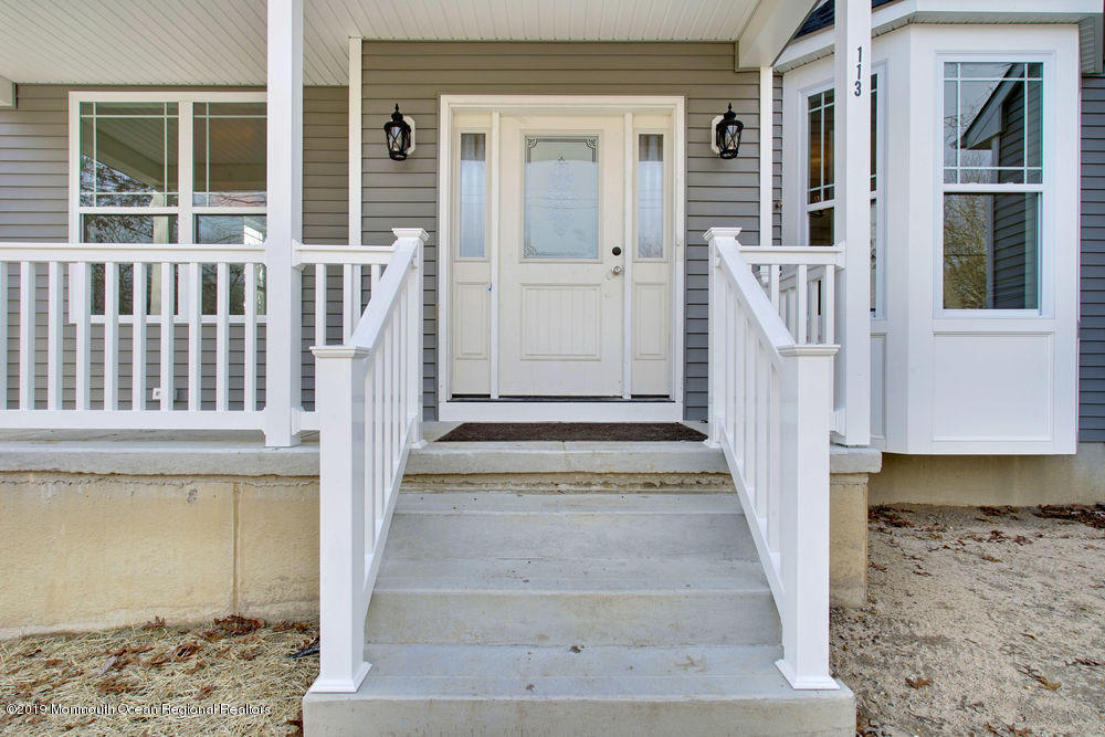 113 Lanyard Road Manahawkin, NJ 08050 - Photo 63 of 71 a view of a balcony with wooden floor and a house