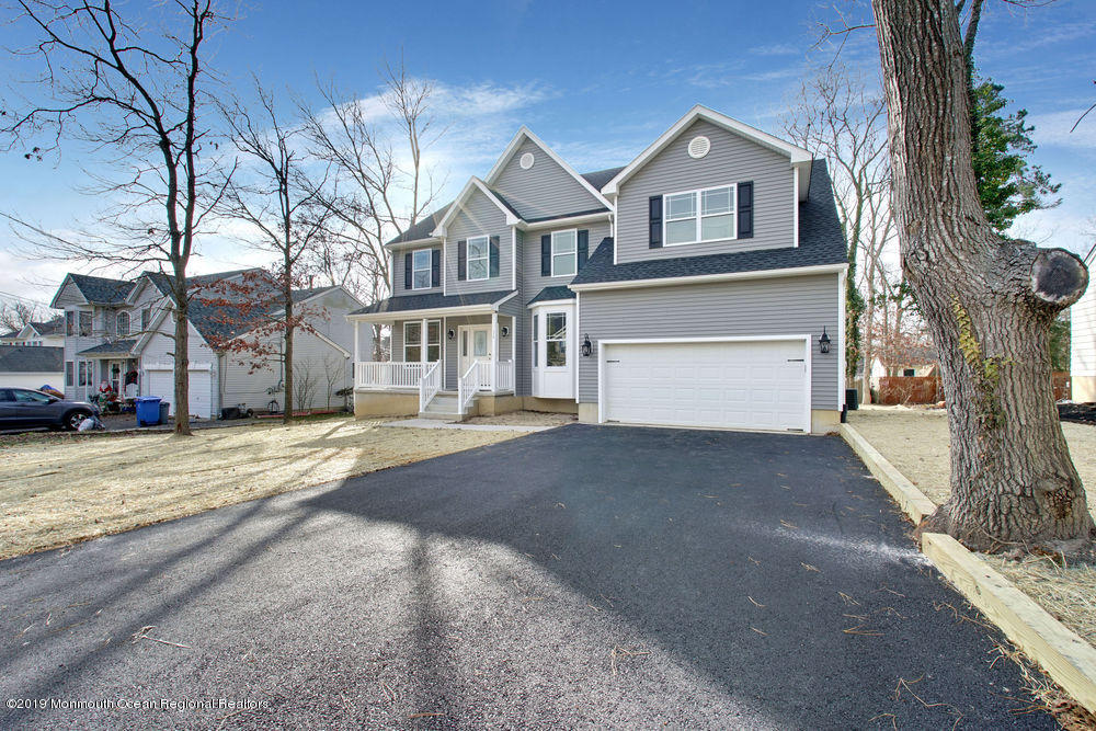 113 Lanyard Road Manahawkin, NJ 08050 - Photo 64 of 71 a front view of a house with a yard and garage