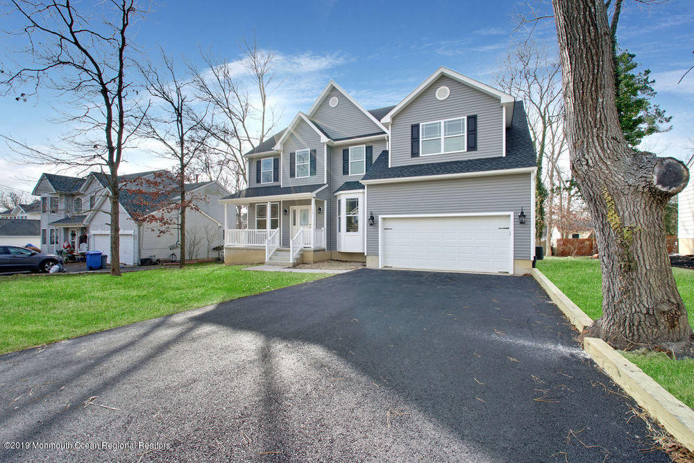 113 Lanyard Road Manahawkin, NJ 08050 - Photo 7 of 71 a front view of a house with a yard and garage