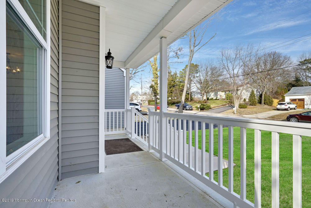 113 Lanyard Road Manahawkin, NJ 08050 - Photo 9 of 71 a view of a porch with a floor to ceiling window and tree