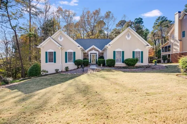 a front view of a house with a yard and garage