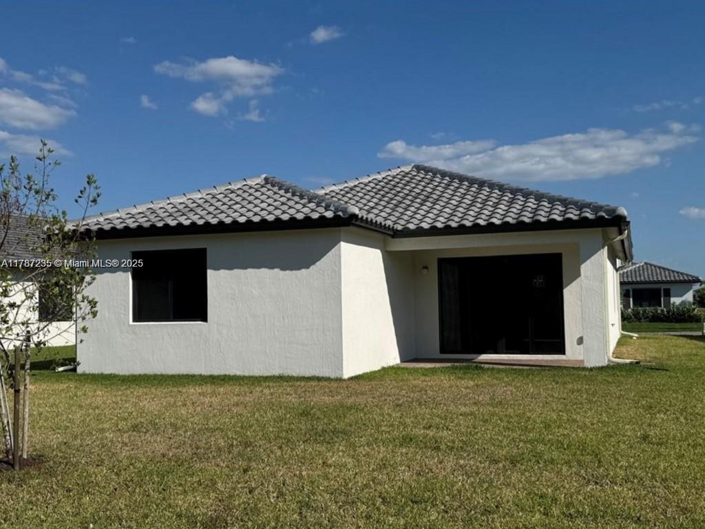 5277 Marano Drive Ave Maria, FL 34142 - Photo 15 of 23 a front view of a house with a yard