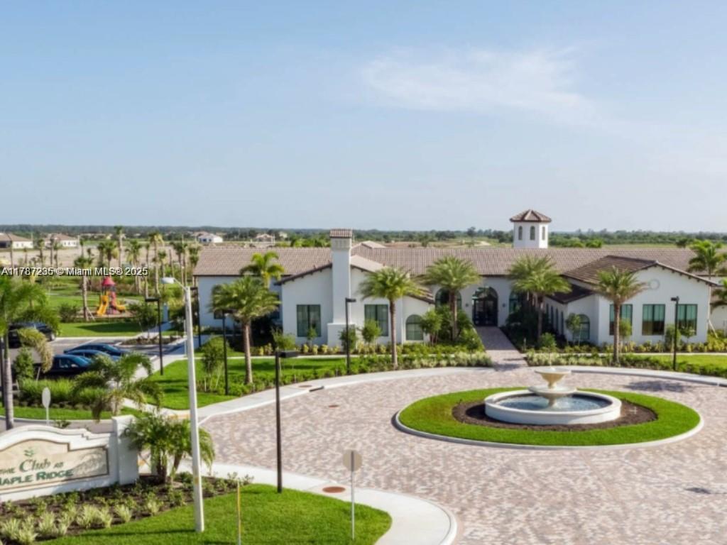 5277 Marano Drive Ave Maria, FL 34142 - Photo 19 of 23 a swimming pool with lots of green space and glass windows