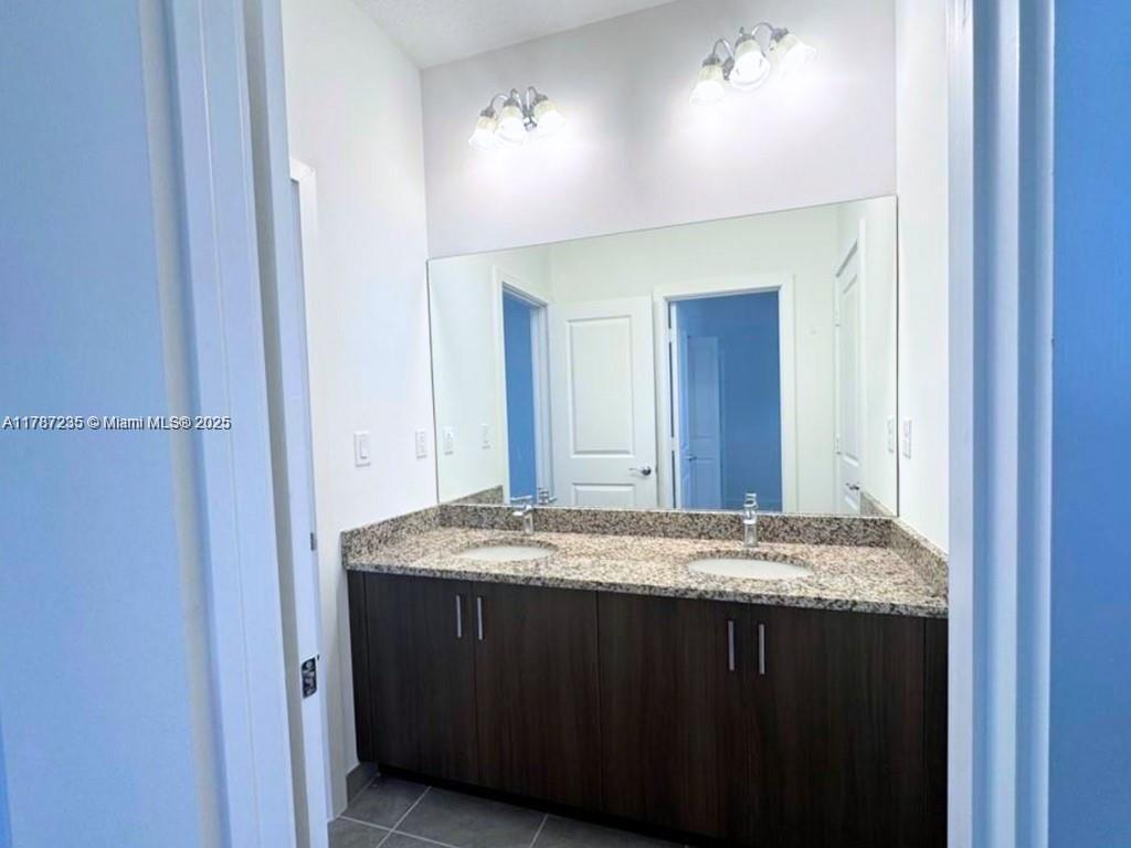 5277 Marano Drive Ave Maria, FL 34142 - Photo 9 of 23 a bathroom with a granite countertop sink and a mirror