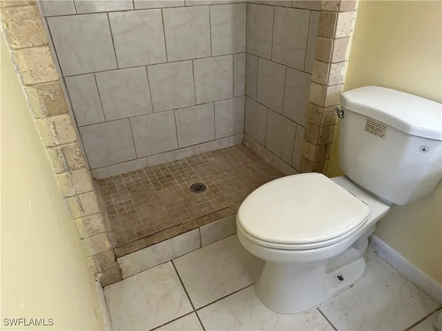 a white toilet sitting next to a bathroom sink