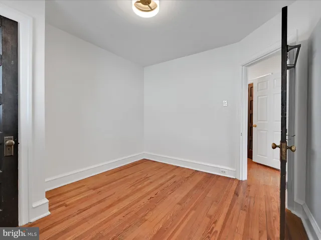 an empty room with wooden floor and closet