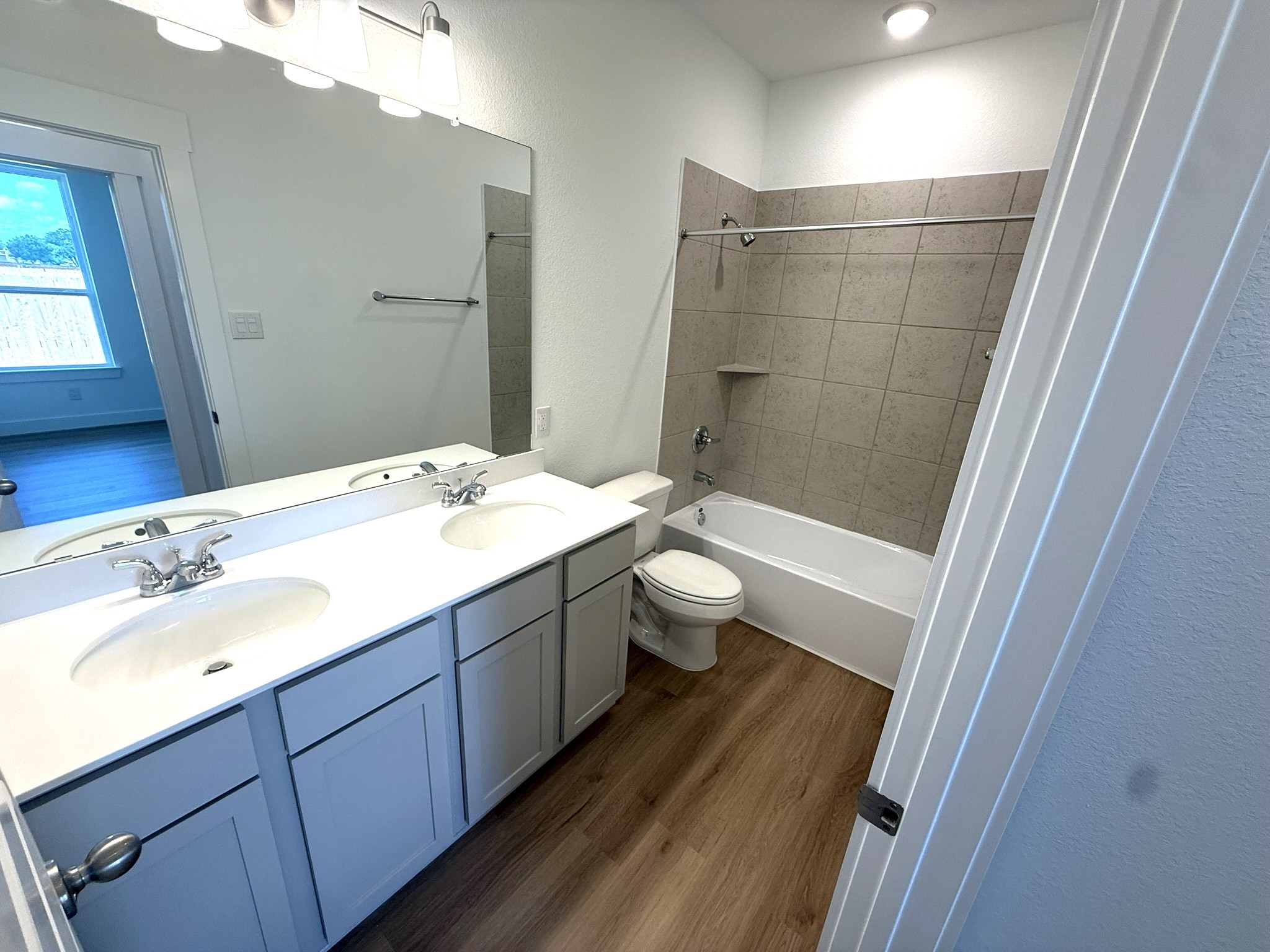 5314 Grace Sunshine Spring Spring, TX 77379 - Photo 15 of 23 Each bathroom is a testament to thoughtful construction, featuring sleek fixtures that not only look fabulous but also make your family's daily routine a little more enjoyable.