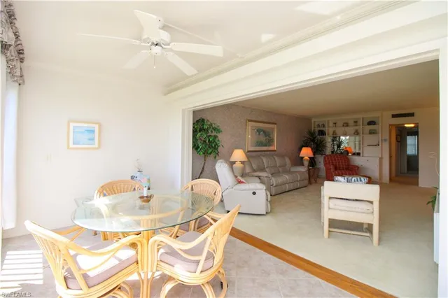 a view of a dining room with furniture and a chandelier