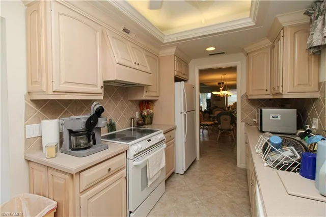 a kitchen with stainless steel appliances granite countertop a stove and a refrigerator