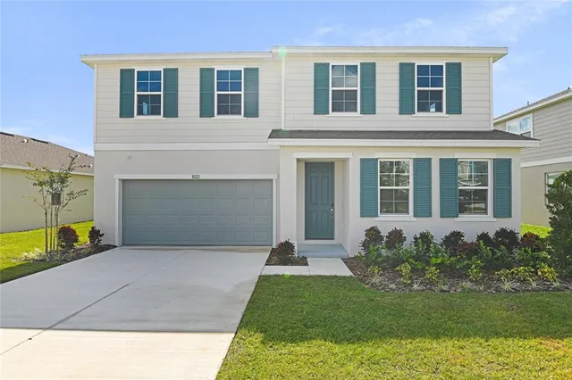 a view of a house with backyard and garden