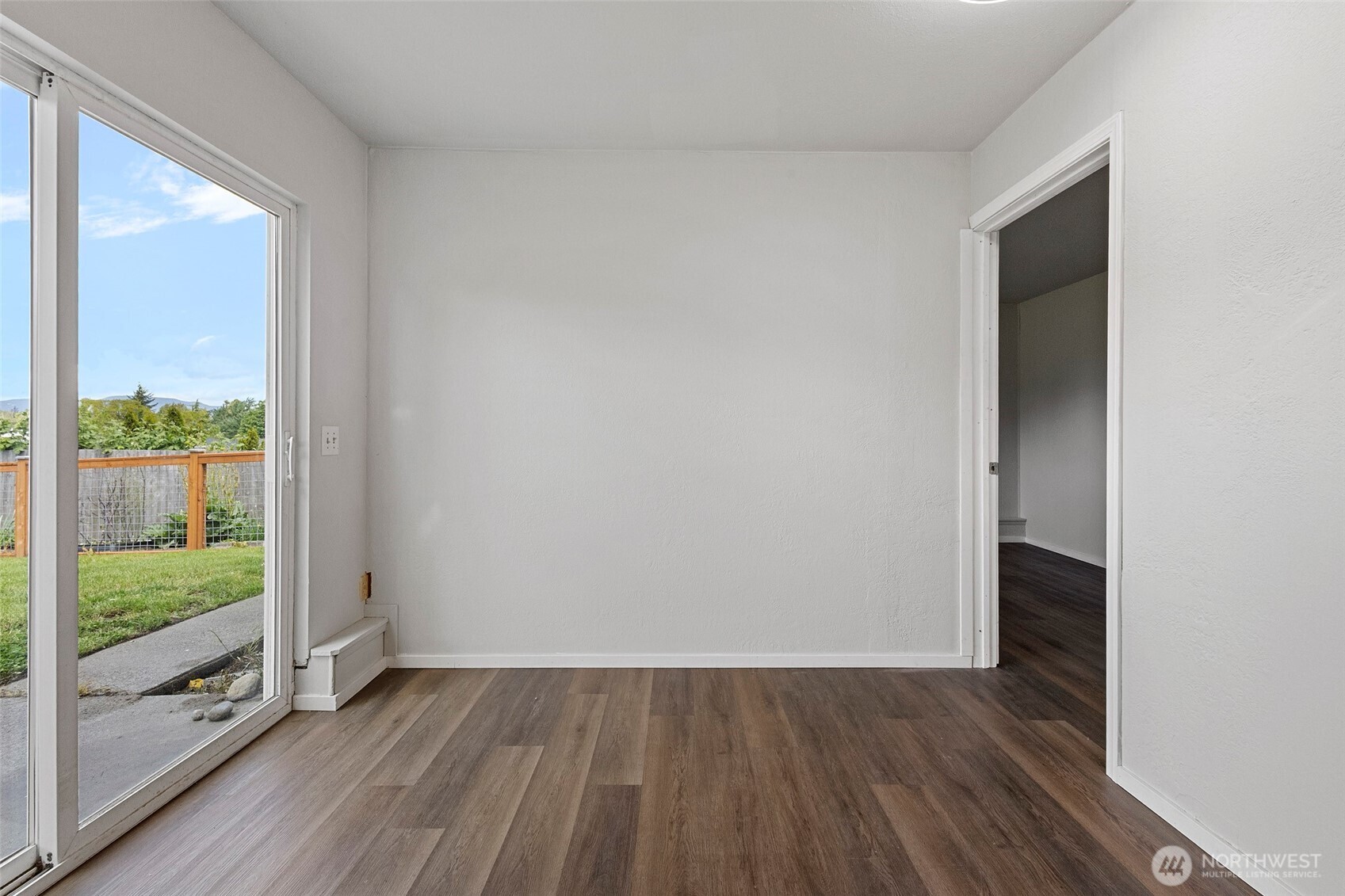 3812 R Avenue Anacortes, WA 98221 - Photo 27 of 36 a view of an empty room with glass door and wooden floor