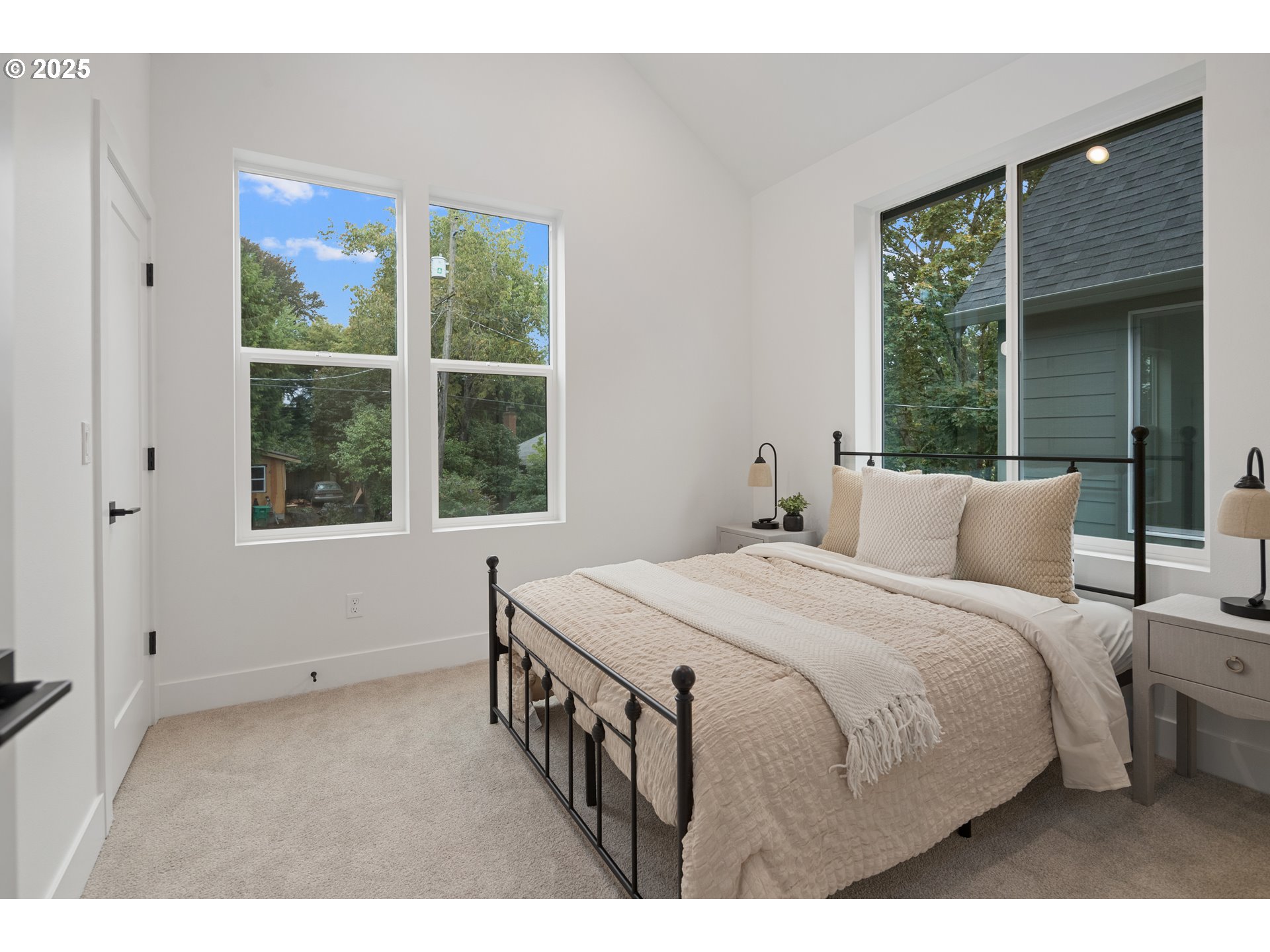 4031 Southeast Tibbetts Street Portland, OR 97202 - Photo 16 of 21 a bedroom with a large bed and a large window
