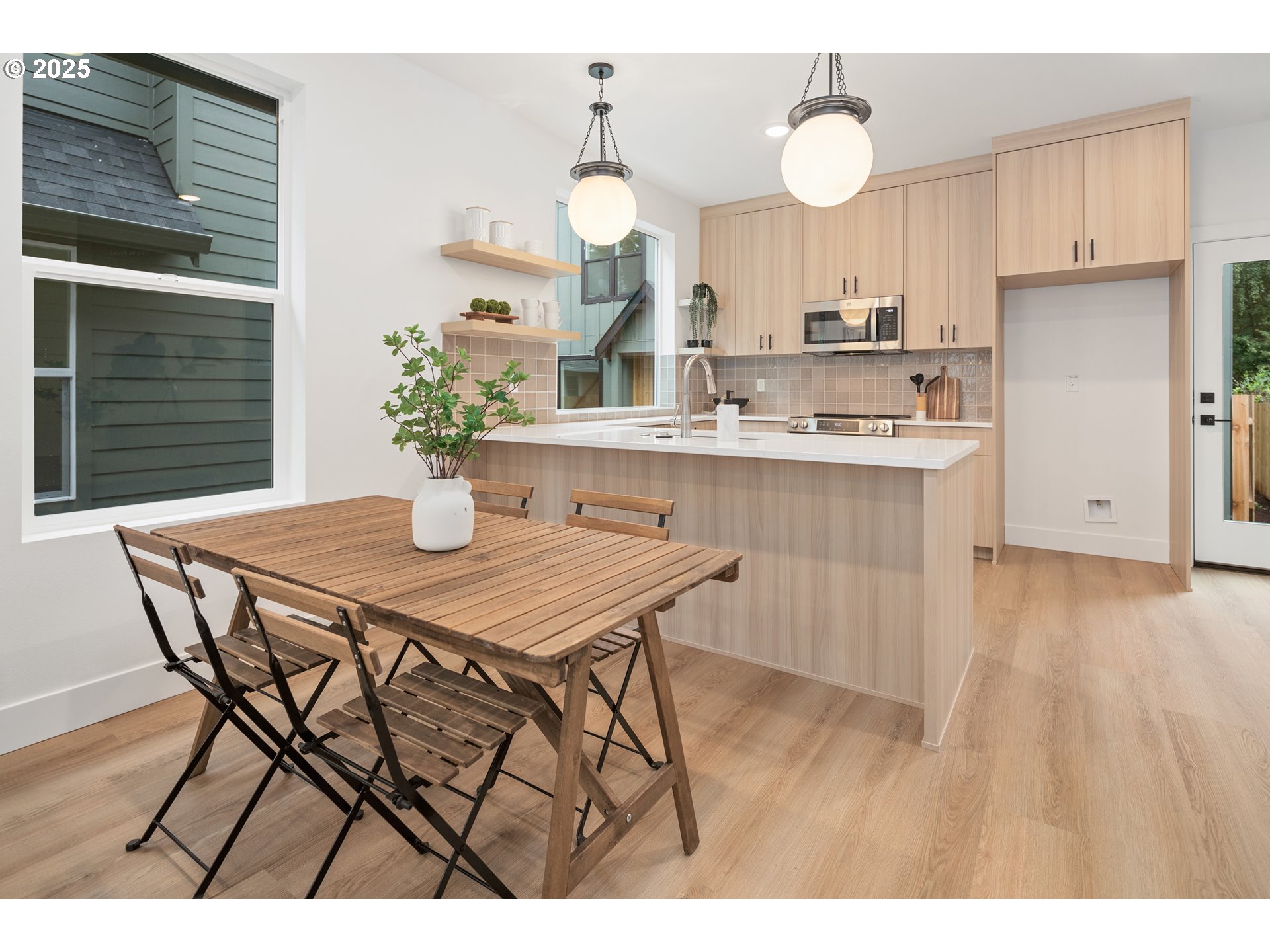 4031 Southeast Tibbetts Street Portland, OR 97202 - Photo 4 of 21 a kitchen with stainless steel appliances granite countertop a kitchen island a stove a cabinets a sink and a dining table