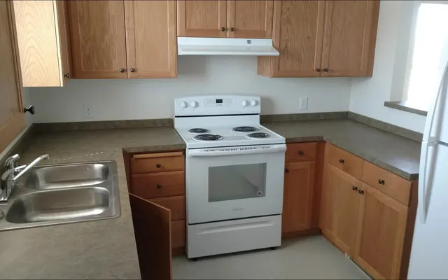 a kitchen with a stove and a sink