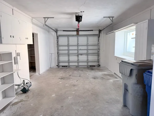 a bathroom with a window sink and cabinets