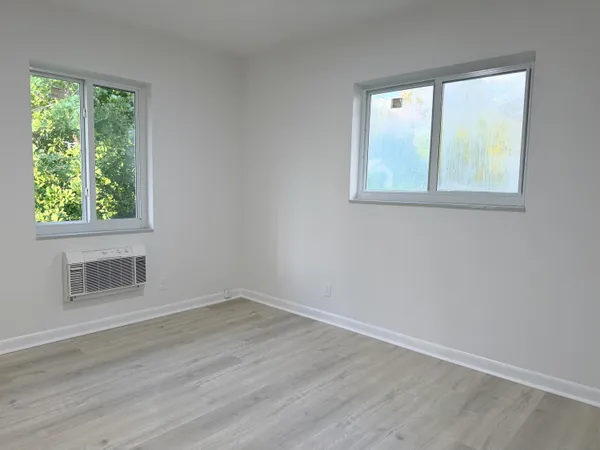 a kitchen with white cabinets and sink