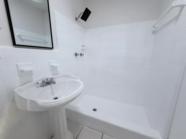 a bathroom with a sink a toilet and mirror