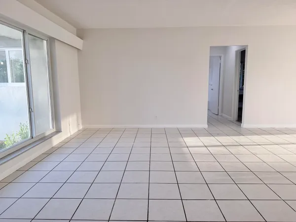 a kitchen with white cabinets and a refrigerator