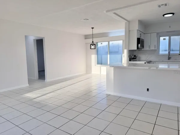 a view of a kitchen and a window in a kitchen