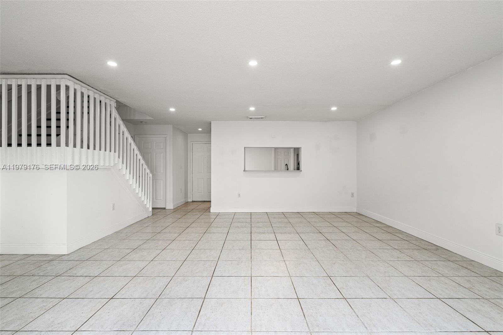 7413 Southwest 162nd Path Miami, FL 33193 - Photo 12 of 44 an empty room with white walls and entryway