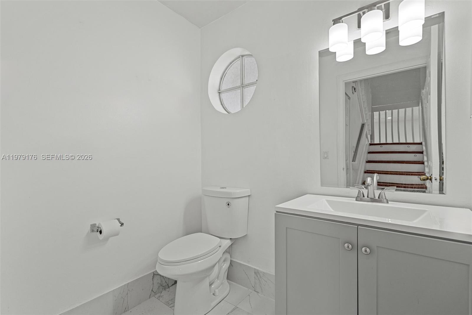 7413 Southwest 162nd Path Miami, FL 33193 - Photo 19 of 44 a bathroom with a sink vanity mirror and toilet