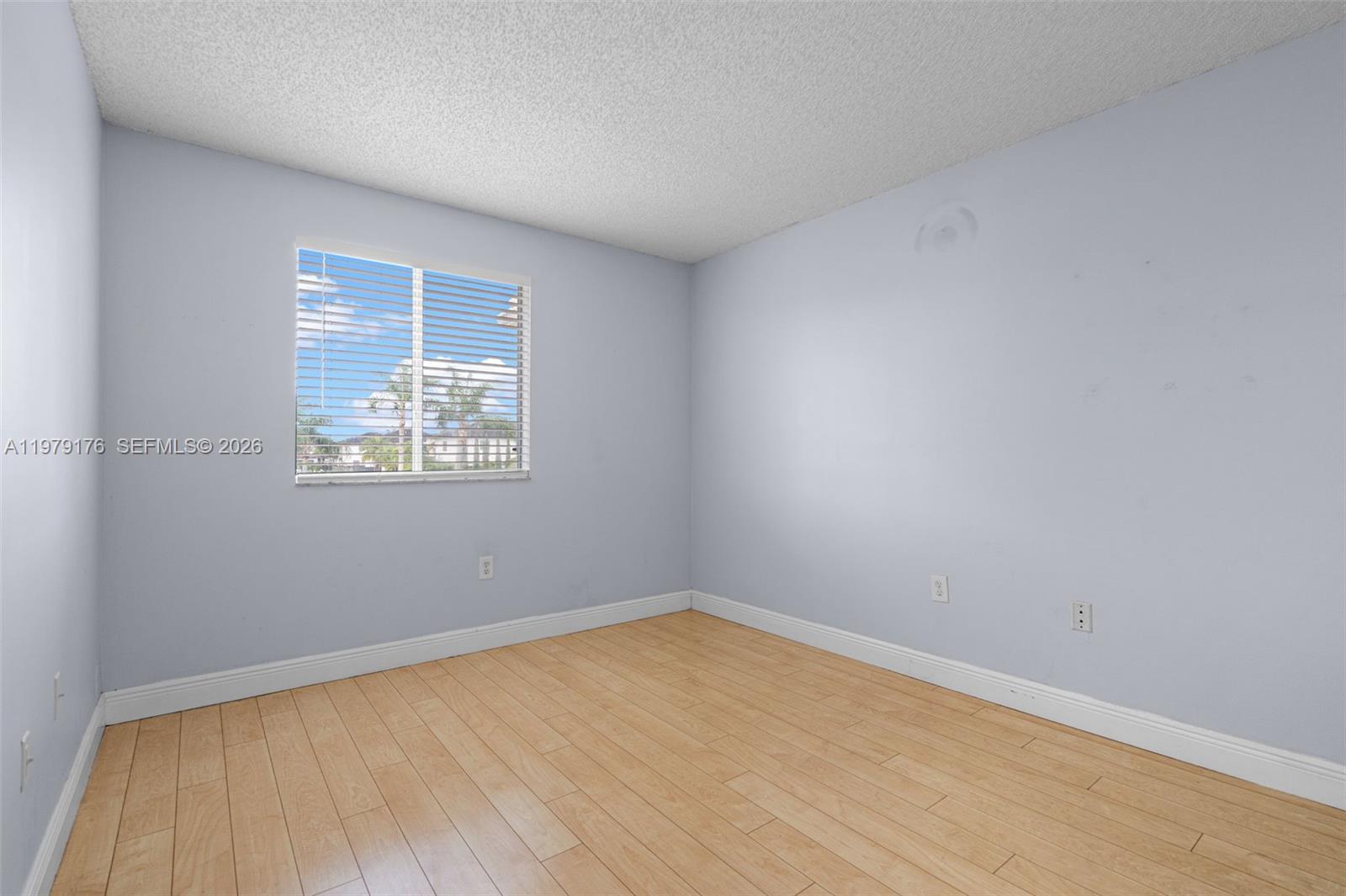 7413 Southwest 162nd Path Miami, FL 33193 - Photo 27 of 44 a view of an empty room with wooden floor and a window