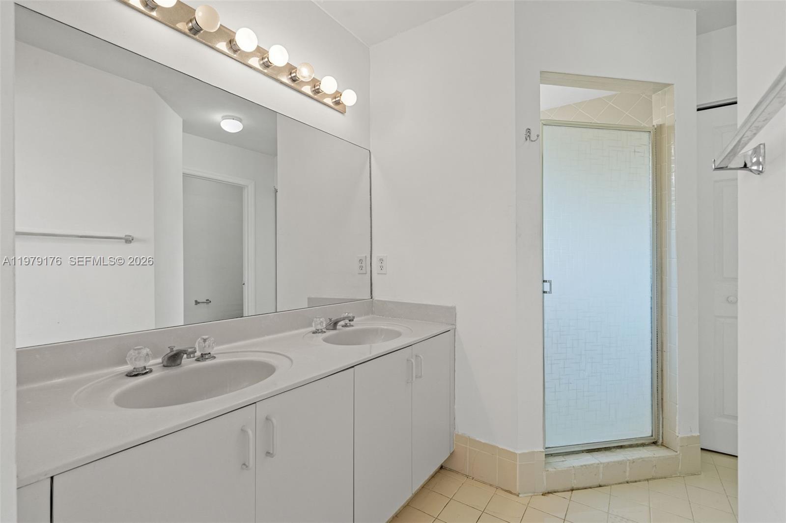 7413 Southwest 162nd Path Miami, FL 33193 - Photo 34 of 44 a bathroom with a sink double vanity and a mirror