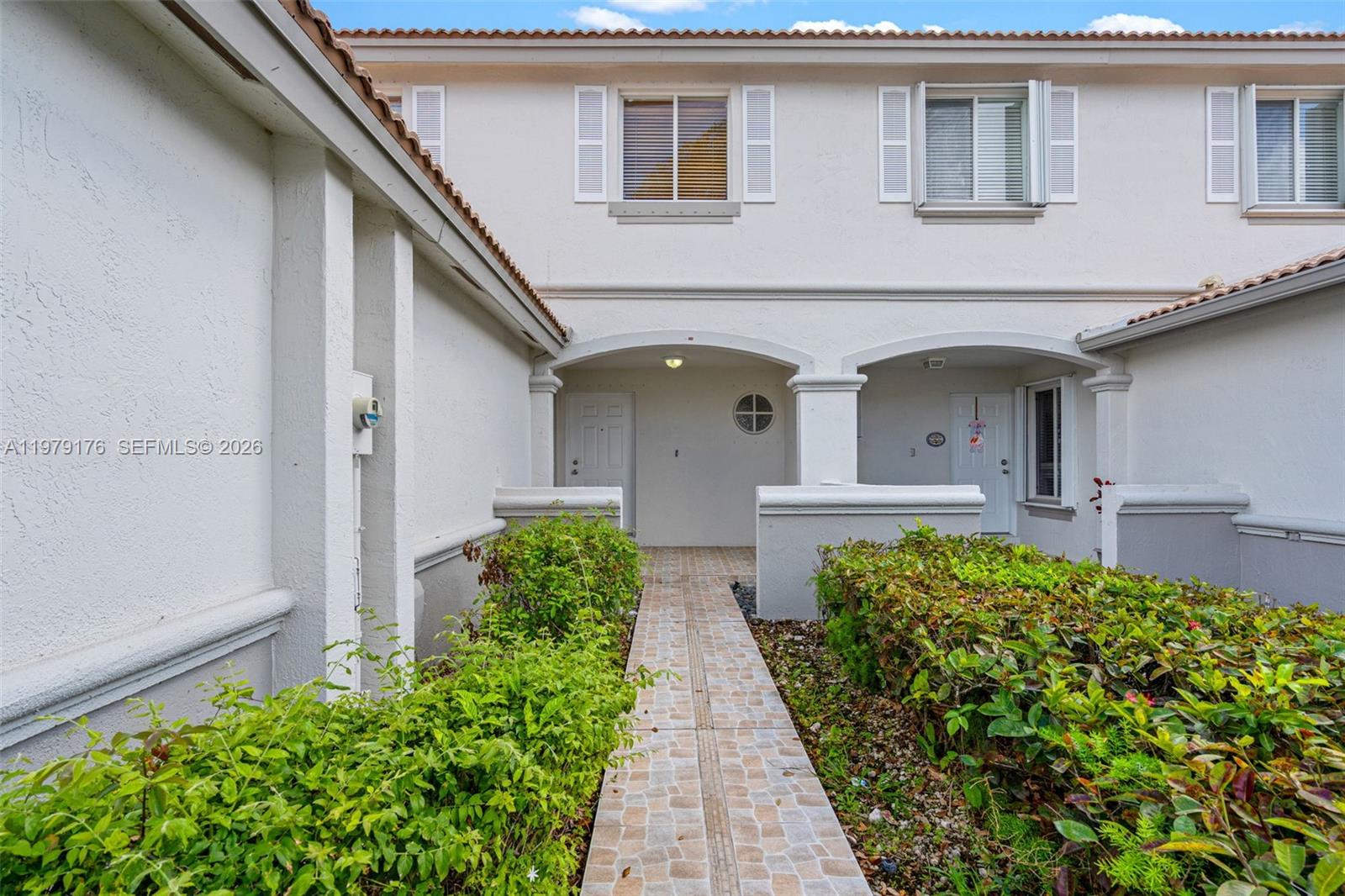 7413 Southwest 162nd Path Miami, FL 33193 - Photo 4 of 44 a front view of a house with garden