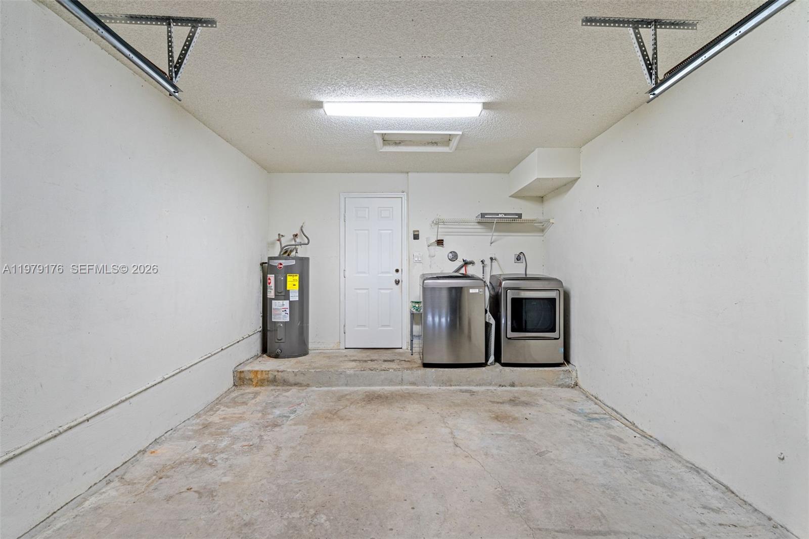 7413 Southwest 162nd Path Miami, FL 33193 - Photo 42 of 44 a view of a storage & utility room with a washer and dryer