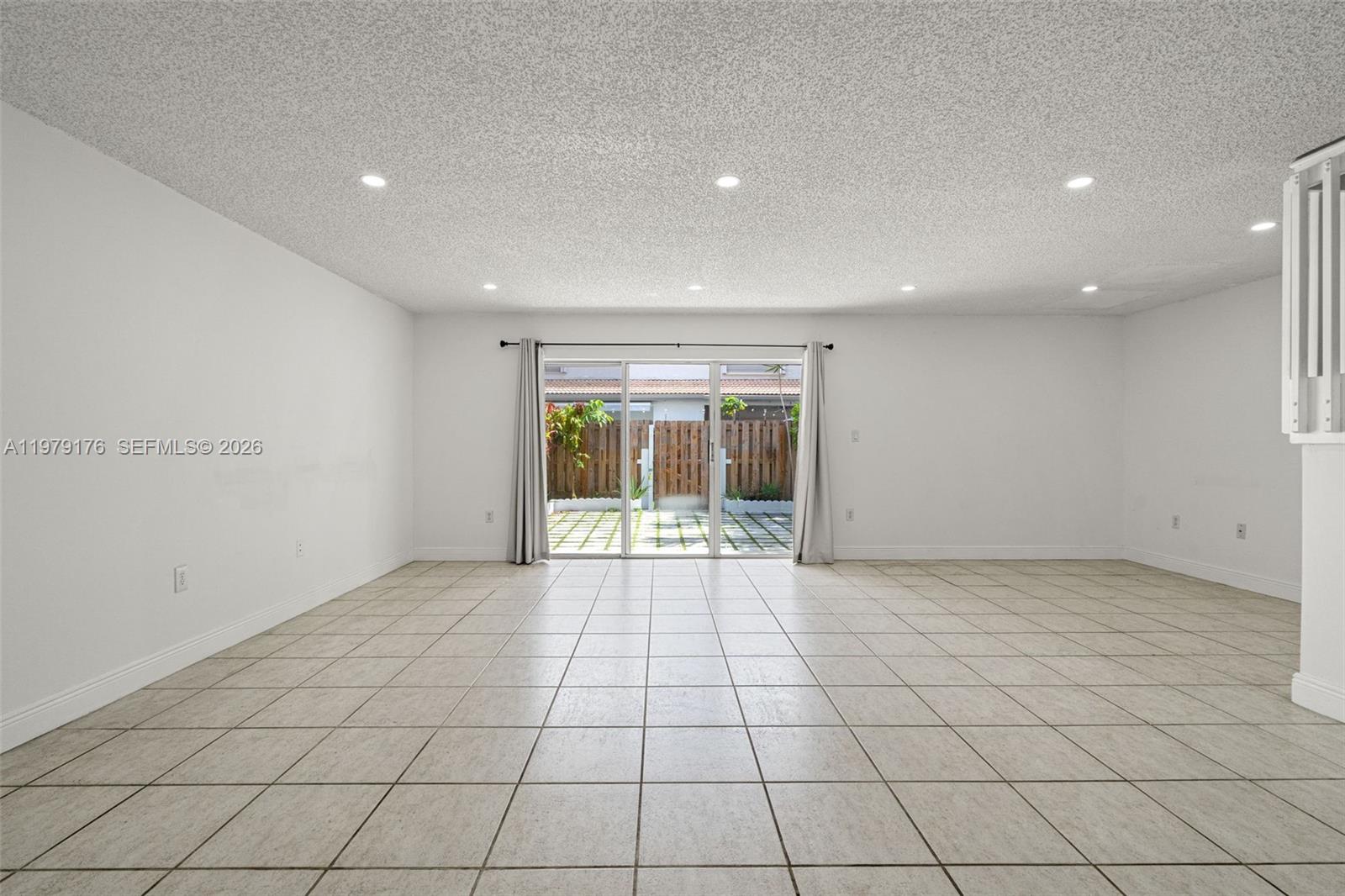 7413 Southwest 162nd Path Miami, FL 33193 - Photo 9 of 44 a view of an empty room with a window