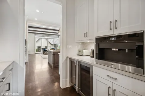 a large kitchen with a table and chairs