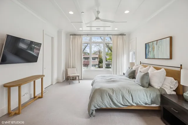 a bedroom with a bed and a television