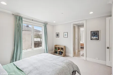 a spacious bedroom with a bed and a window