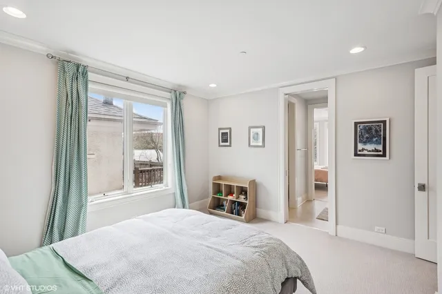 a spacious bedroom with a bed and a window