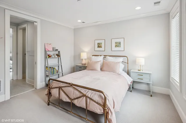 a spacious bedroom with a bed and a window