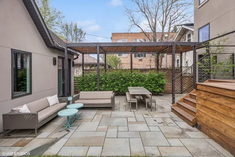 a view of a house with backyard porch and sitting area