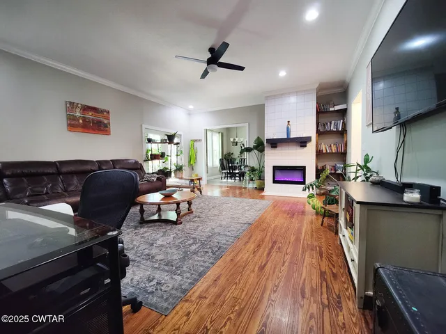 a living room with fireplace furniture and a wooden floor