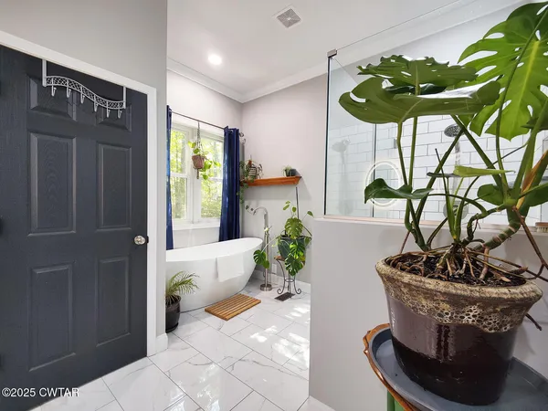 a vase of flowers sitting on a table with window